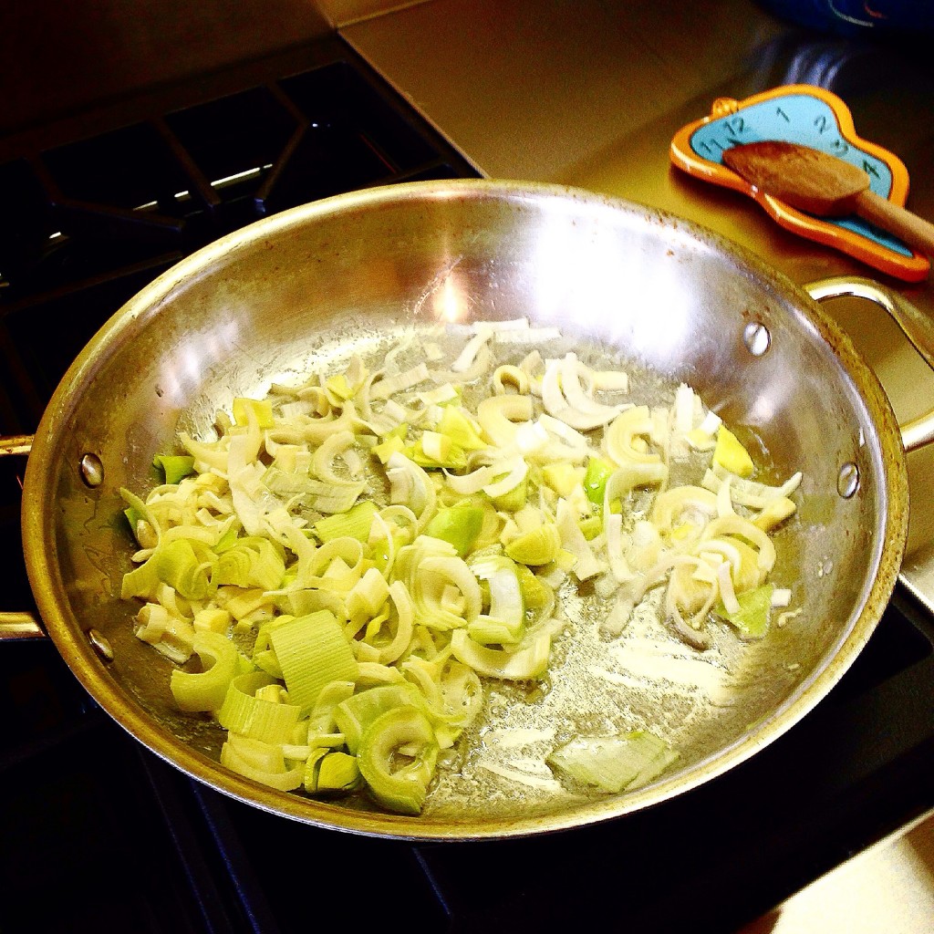 Sauteing spring onions in butter.